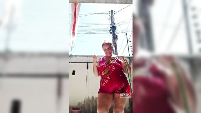 Old lady dona vera costa taking a shower with a mangueira