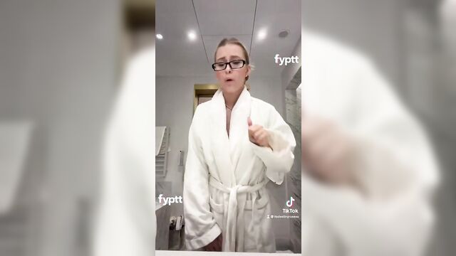 A sexy girl is dancing with her boobs out after dropping the robe