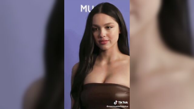 Olivia rodrigo's brown top scene featuring an ai-generated nude version