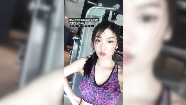 Fit indonesian girl is doing gymnastics in the gym