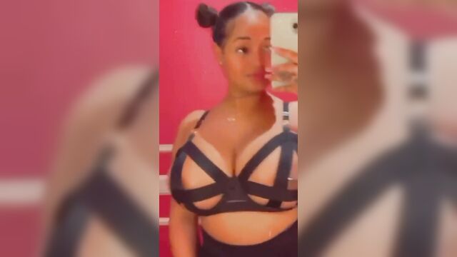 A girl with big tits plays with a metal plug in each nipple